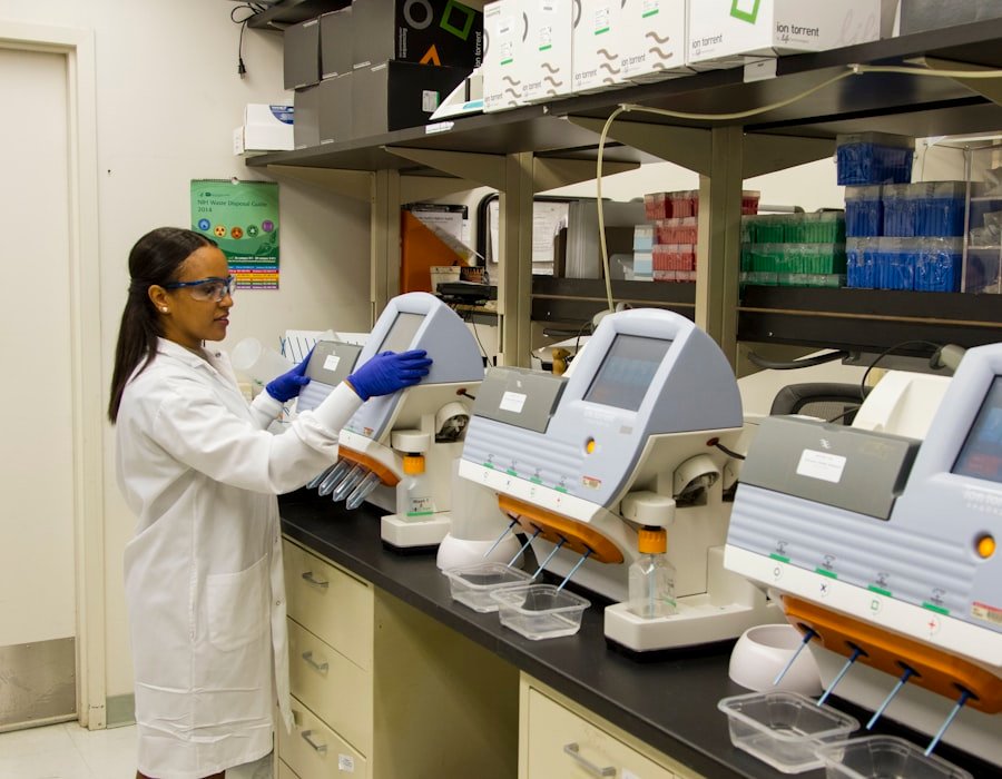A laboratory technician working with analysis equipment