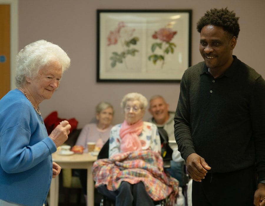 A care worker greeting residents in a bright communal living room