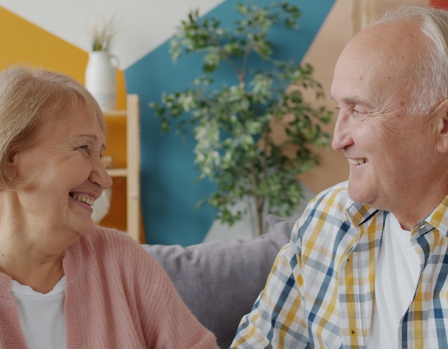 An older couple sitting together and smiling at home