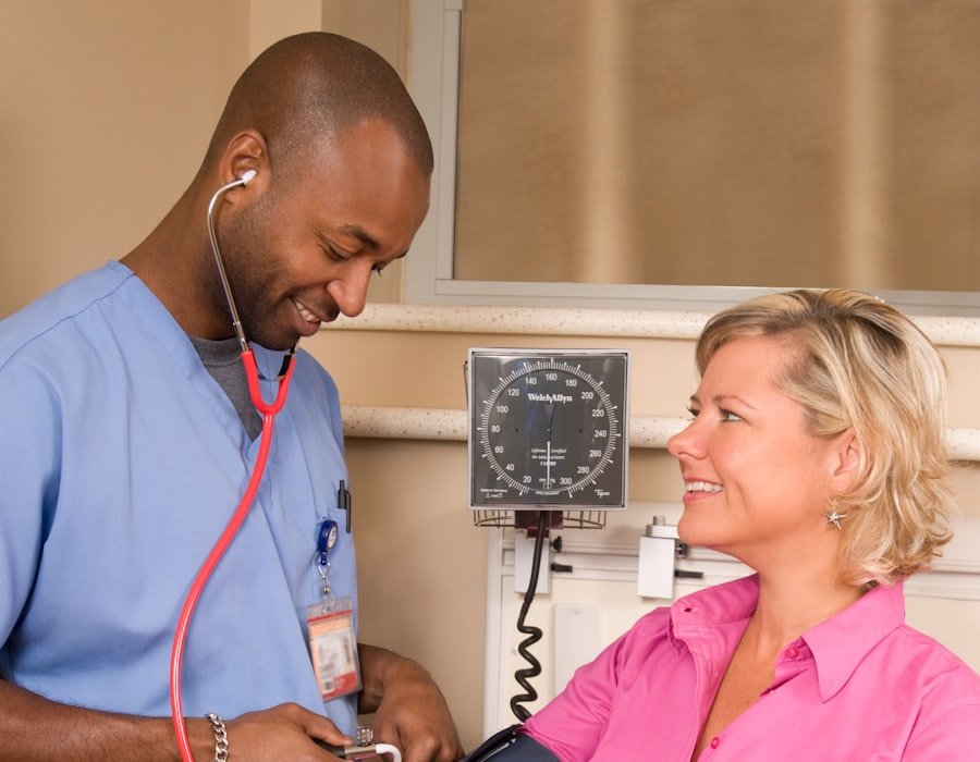 A healthcare worker checking a patient's blood pressure during a consultation