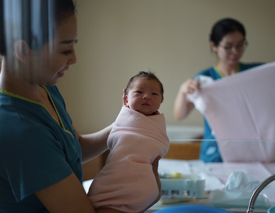 A nurse caring for a mother and her newborn baby